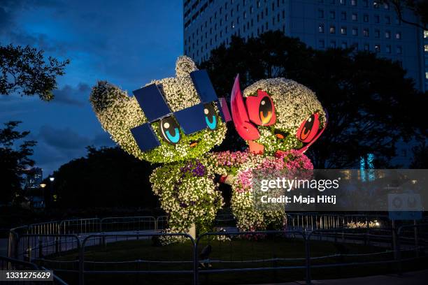 Floral arrangements of Mascots of Tokyo 2020 Olympic Games, Miraitowa and Someity are illuminated at twilight during Day Six of the Tokyo Olympic...