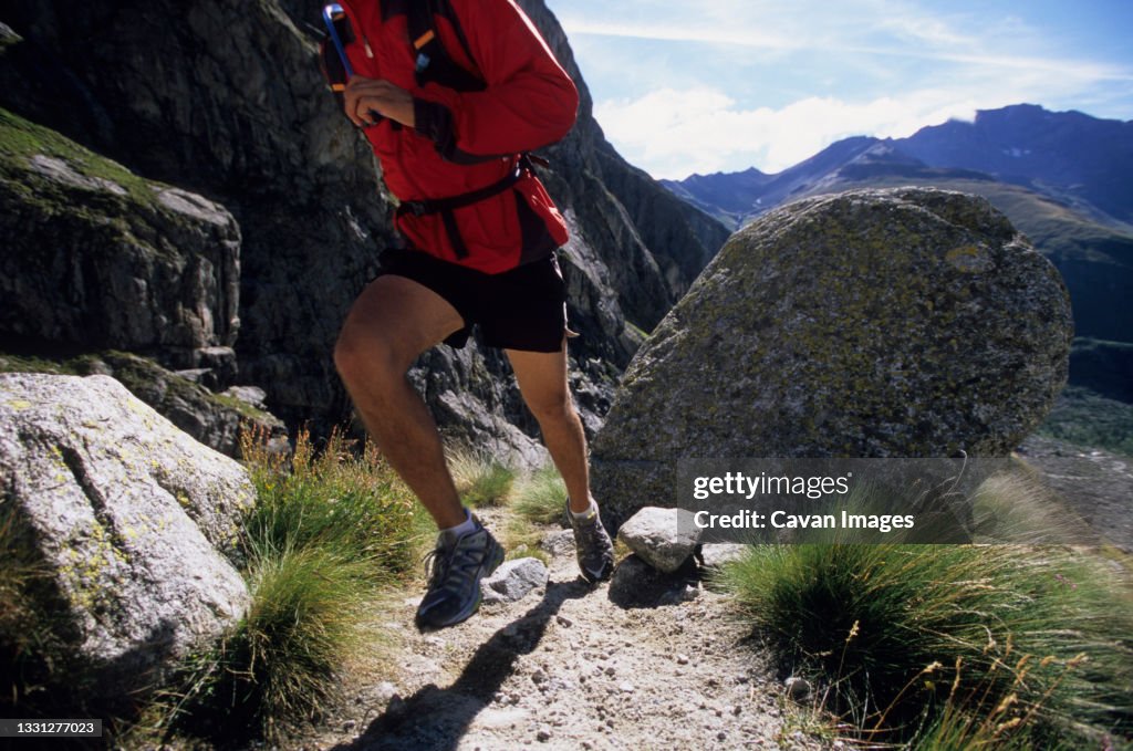Man trail running in Val De Malatra, Courmayeur, Italy.