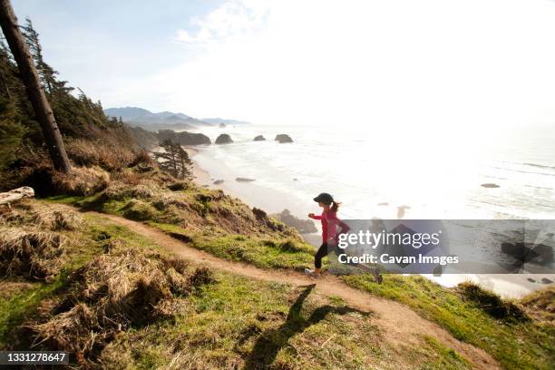 woman trail running along the oregon coast. - beach trail stock pictures, royalty-free photos & images