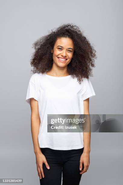 cheerful young woman in white t-shirt - black white stockfoto's en -beelden