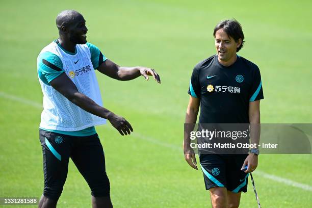 Romelu Lukaku of FC Internazionale and Head Coach Simone Inzaghi of FC Internazionale smile during the FC Internazionale training session at the...