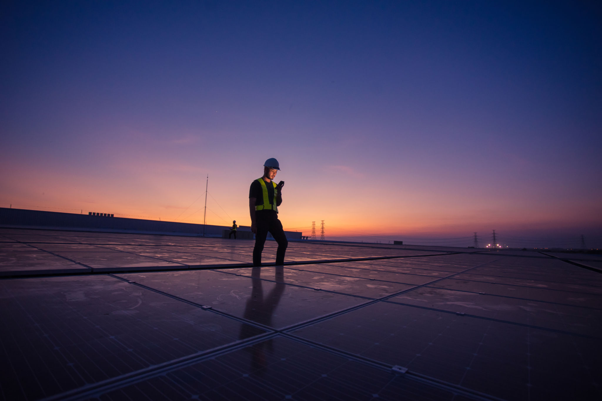 Engineer service check installation solar cell on the roof of factory on the morning. Engineer service check installation solar cell on the roof of factory on the morning.