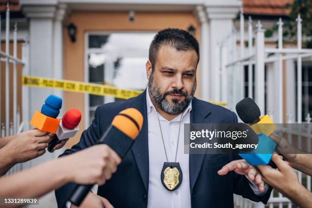police chief walking by reporters - police press conference stock pictures, royalty-free photos & images