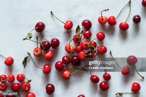 background of fresh organic homegrown summer cherries - cherry stock pictures, royalty-free photos & images