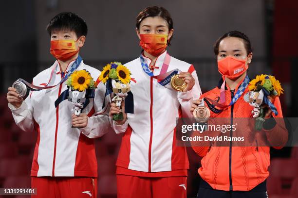 Sun Yingsha and Chen Meng of Team China, and Ito Mima of Team Japan pose for photographs during the medal ceremony of the Women's Singles table...