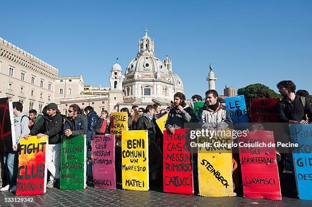 Protesters hold placards as they take to the streets to demonstrate against the new technical government of Italian Prime Minister Mario Monti on...