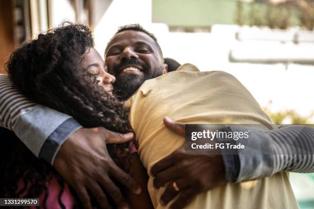 father embracing son and daughter at home - congratulating child stock pictures, royalty-free photos & images