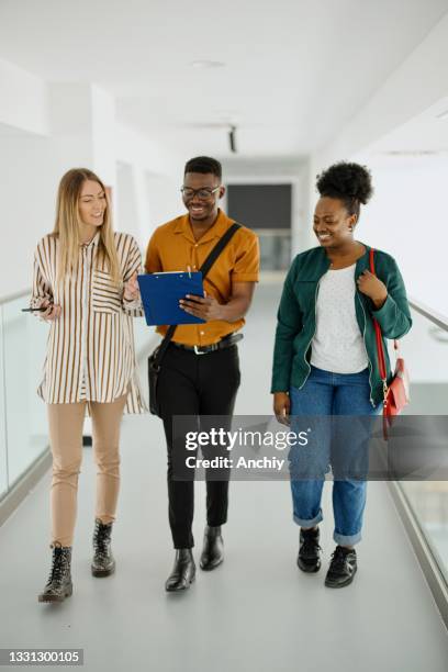 university students walking to their next class. - campus safety stock pictures, royalty-free photos & images