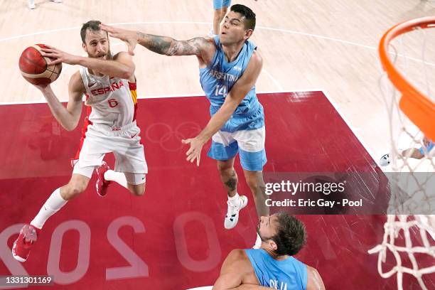 Sergio Rodriguez of Team Spain drives to the basket against Gabriel Deck of Team Argentina during the first half of a Men's Preliminary Round Group C...