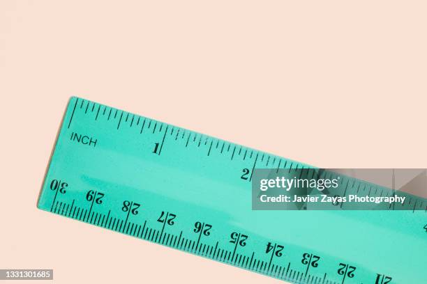 green ruler on pastel background - centimetre stock pictures, royalty-free photos & images