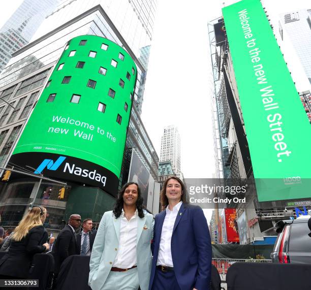 Baiju Bhatt and Vlad Tenev pose in Times Square on Robinhood Markets IPO Listing Day on July 29, 2021 in New York City.