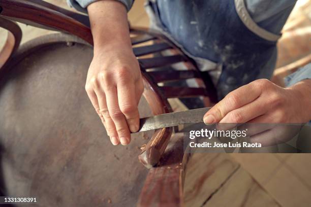 professional carpenter sanding and refinishing wood surface. - restoring chair stock pictures, royalty-free photos & images