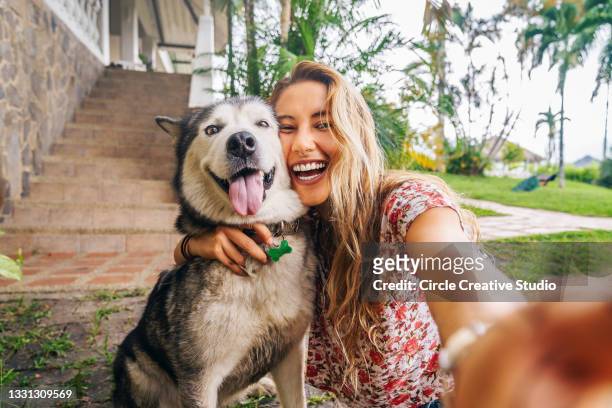 young woman takes selfie with her dog - huisdiereigenaar stockfoto's en -beelden