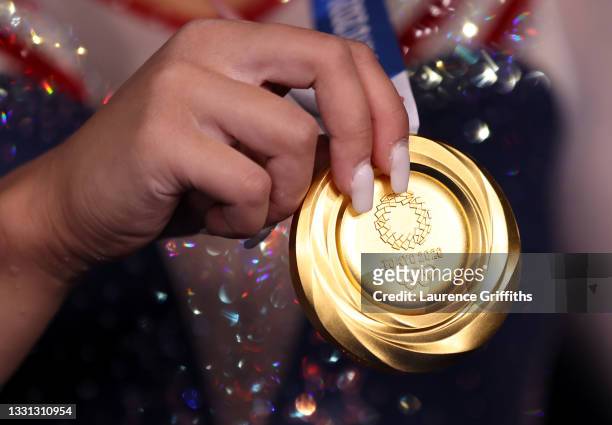 Detailed view of Sunisa Lee of Team United States holding her gold medal after winning the Women's All-Around Final on day six of the Tokyo 2020...
