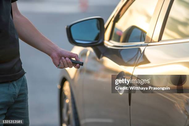man hand unlocking car - car alarm stock-fotos und bilder