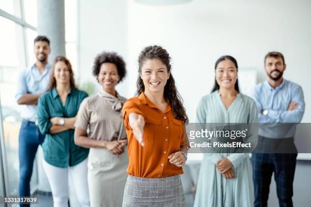 businesswoman offering handshake - diverse professionals hands stockfoto's en -beelden
