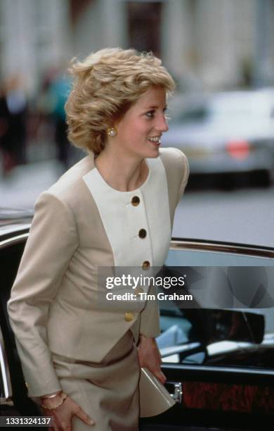 British Royal Diana, Princess of Wales , wearing a beige-and-white suit by Catherine Walker, leaves King Edward VII's Hospital Sister Agnes in...