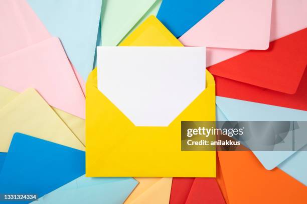 multi colored envelopes - yellow envelope stock pictures, royalty-free photos & images