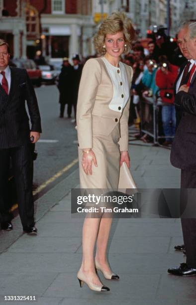 British Royal Diana, Princess of Wales , wearing a beige-and-white suit by Catherine Walker, leaves King Edward VII's Hospital Sister Agnes in...