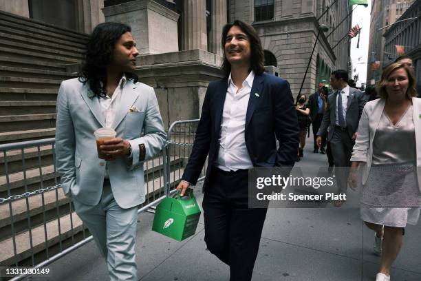 Baiju Bhatt and Vlad Tenev, founders of the online brokerage Robinhood, walk along Wall Street after going public with an IPO earlier in the day on...