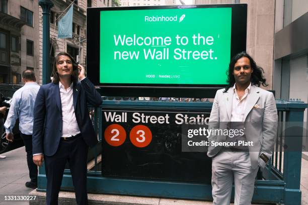 Baiju Bhatt and Vlad Tenev, founders of the online brokerage Robinhood, walk along Wall Street after going public with an IPO earlier in the day on...