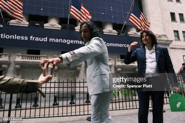 Baiju Bhatt and Vlad Tenev, founders of the online brokerage Robinhood, walk along Wall Street after going public with an IPO earlier in the day on...