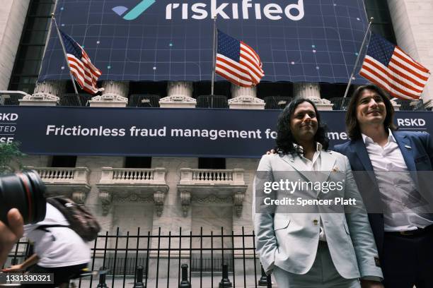 Baiju Bhatt and Vlad Tenev, founders of the online brokerage Robinhood, walk along Wall Street after going public with an IPO earlier in the day on...