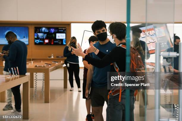 People visit the Apple store in the Oculus Mall in Manhattan on July 29, 2021 in New York City. Numerous stores in the mall, including the Apple...