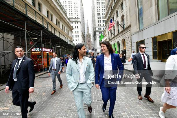 Baiju Bhatt and Vlad Tenev walk on Wall Street during Robinhood Markets IPO Listing Day on July 29, 2021 in New York City.