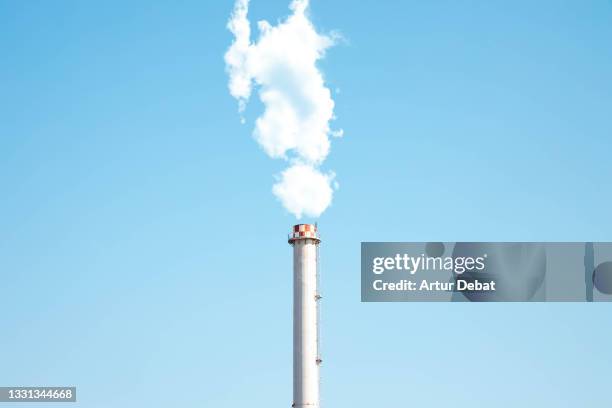 industry chimney with white smoke stack against blue sky. - chimney ストックフォトと画像