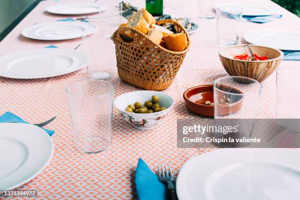 closeup of family meal table in spain - wohltätigkeitsfest stock-fotos und bilder