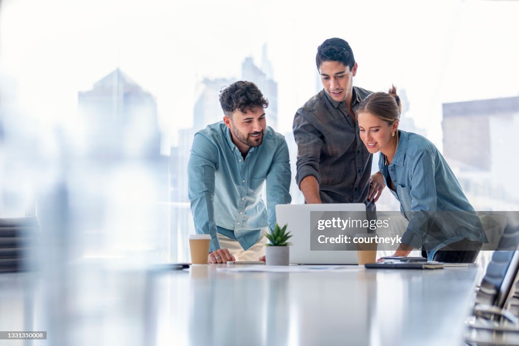 Business team working on a laptop computer.