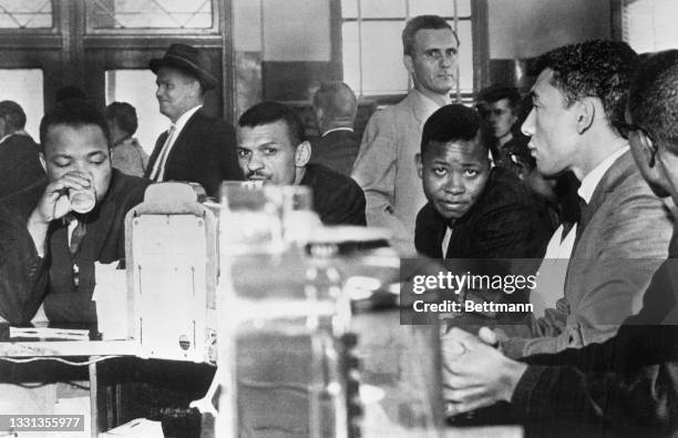 Freedom riders drink coffee at a bus depot coffee shop as they wait for their bus to take them out of Alabama.