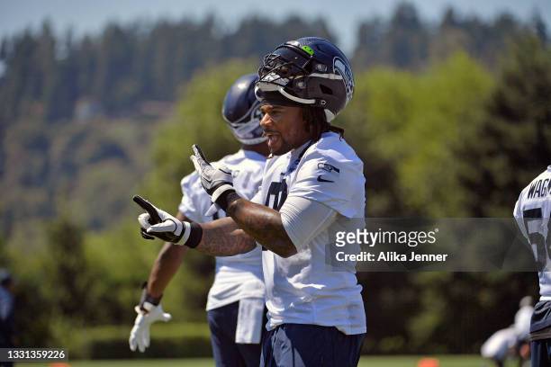 Robert Nkemdiche of the Seattle Seahawks chats with fans during training camp at Virginia Mason Athletic Center on July 29, 2021 in Renton,...