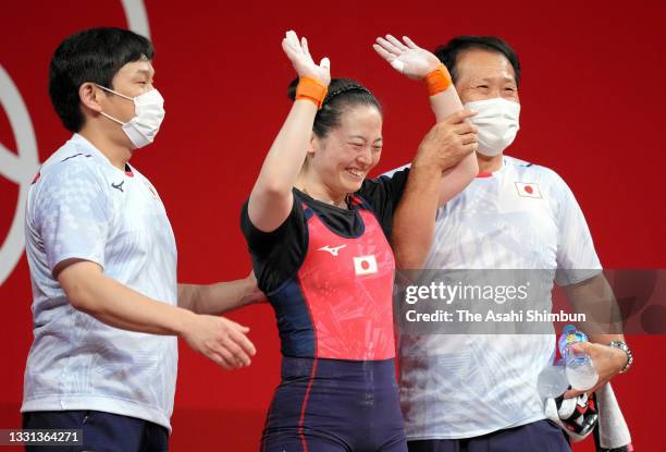 Mikiko Ando of Team Japan celebrates with her coaches while competing in the Women’s 59kg Group A on day four of the Tokyo 2020 Olympic Games at...