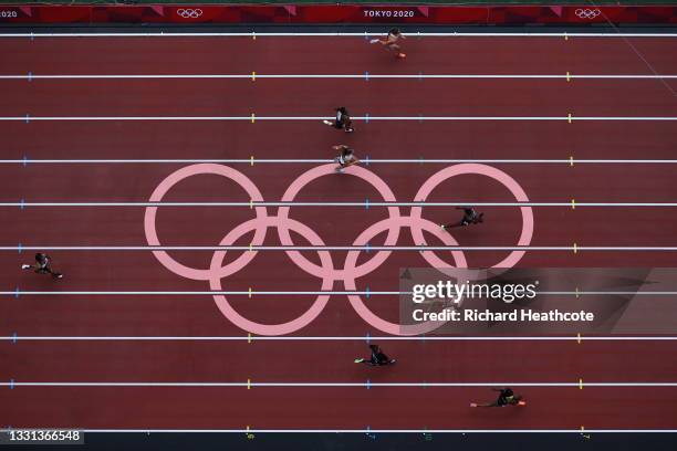 Athletes compete during round one of the Women's 100m Preliminary Round heats on day seven of the Tokyo 2020 Olympic Games at Olympic Stadium on July...