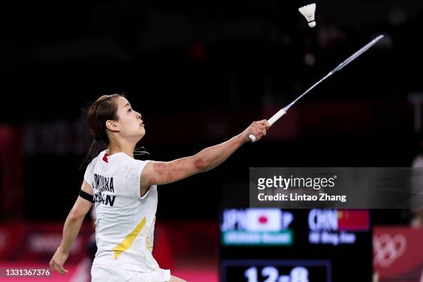 Nozomi Okuhara of Team Japan competes against He Bing Jiao of Team China during a Women's Singles Quarterfinal match on day seven of the Tokyo 2020...
