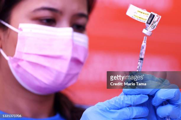 Registered nurse Darryl Hana prepares a dose of the Pfizer COVID-19 vaccine at a three-day vaccination clinic at Providence Wilmington Wellness and...