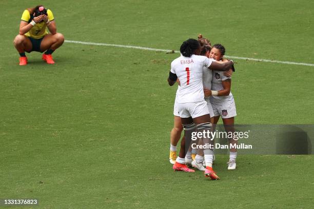 Team United States celebrates defeating Team Australia as Charlotte Caslick of Team Australia looks dejected in the Women’s pool C match between Team...