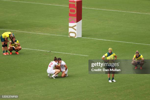 Helena Rowland and Natasha Hunt of Team Great Britain celebrate at fulltime as Charlotte Caslick, Shannon Parry and Dominique du Toit of Team...