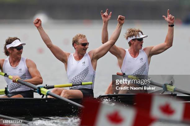 Tom Murray, Hamish Bond and Thomas Mackintosh of Team New Zealand celebrate after winning the gold medal during the Men's Eight Final A on day seven...