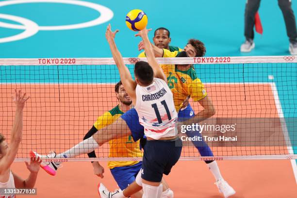 Lucas Saatkamp of Team Brazil hits over Micah Christenson of Team United States during the Men's Preliminary Round - Pool B volleyball on day seven...