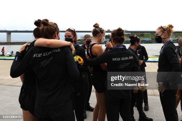 Team New Zealand talk to each other after winning the silver medal during the Women's Eight Final A on day seven of the Tokyo 2020 Olympic Games at...