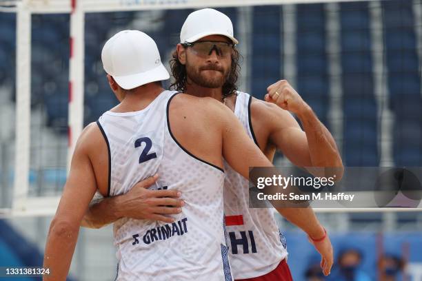 Marco Grimalt of Team Chile celebrates with Esteban Grimalt after defeating Team Morocco during the Men's Preliminary - Pool E beach volleyball on...