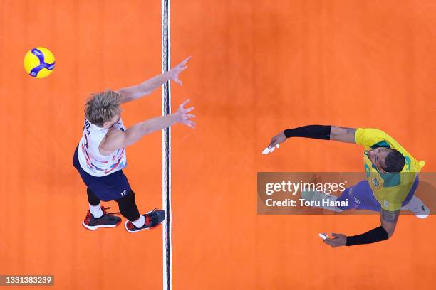 Yoandy Leal Hidalgo of Team Brazil hits past Maxwell Holt of Team United States during the Men's Preliminary Round - Pool B volleyball on day seven...