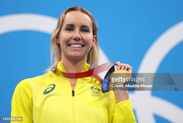 Gold medalist Emma McKeon of Team Australia celebrates on the podium during the medal ceremony for the Women's 100m Freestyle Final on day seven of...
