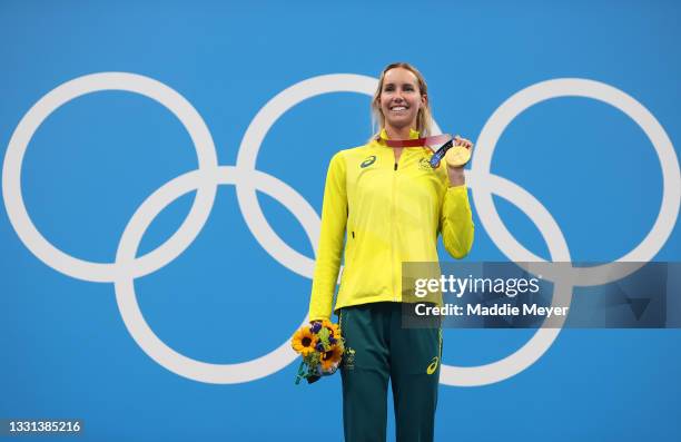 Gold medalist Emma McKeon of Team Australia celebrates on the podium during the medal ceremony for the Women's 100m Freestyle Final on day seven of...