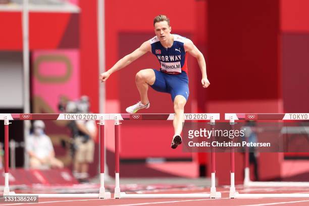 Karsten Warholm of Team Norway competes during round one of the Men's 400m hurdles heats on day seven of the Tokyo 2020 Olympic Games at Olympic...