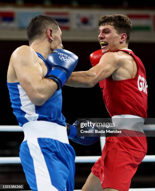 Pat McCormack of Team Great Britain exchanges punches with Bobo Usmon Baturov of Team Uzbekistan during the Men's Welter quarter final on day seven...