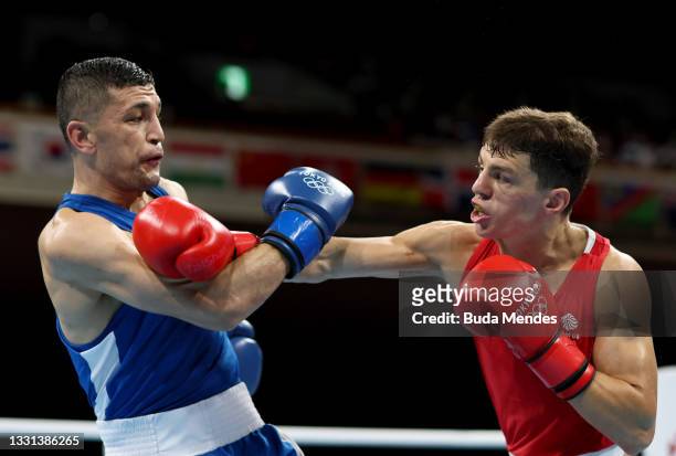 Pat McCormack of Team Great Britain exchanges punches with Bobo Usmon Baturov of Team Uzbekistan during the Men's Welter quarter final on day seven...